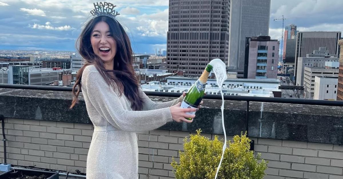 Emma Betsinger pops a bottle of champagne on her birthday.