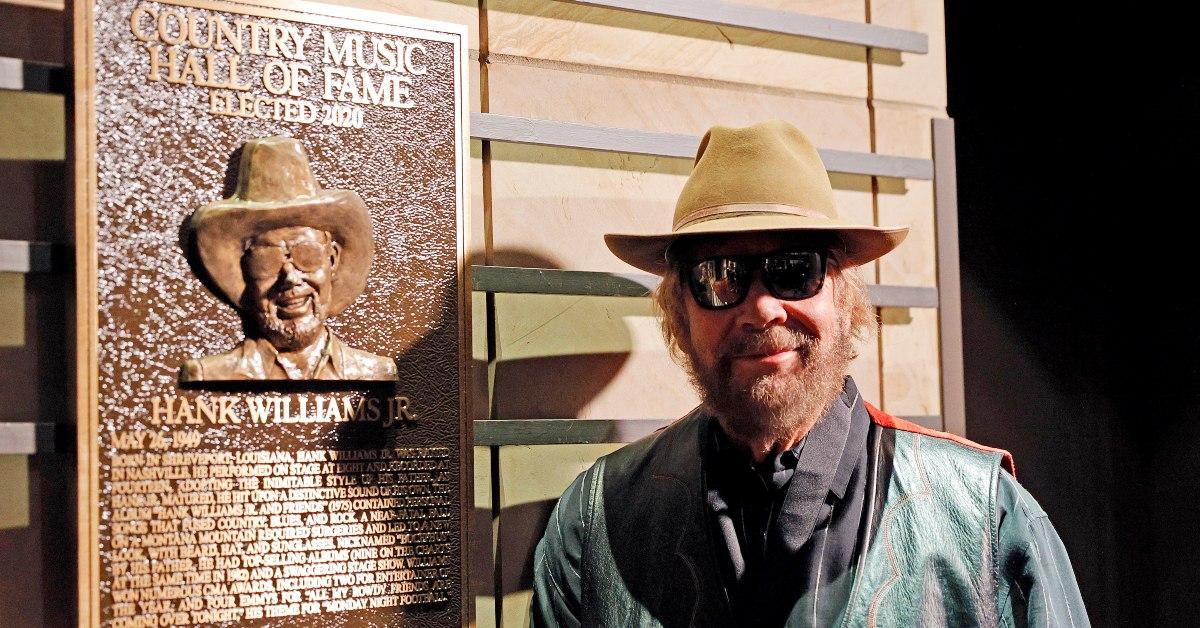 Hank Williams Jr. standing in front of a plaque