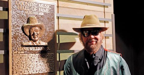 Hank Williams Jr. standing in front of a plaque