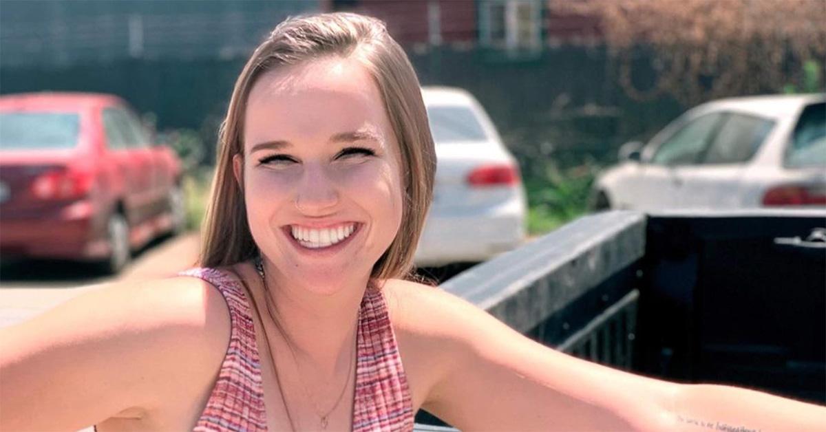 Lulu Conners smiling while leaning on a truck. 