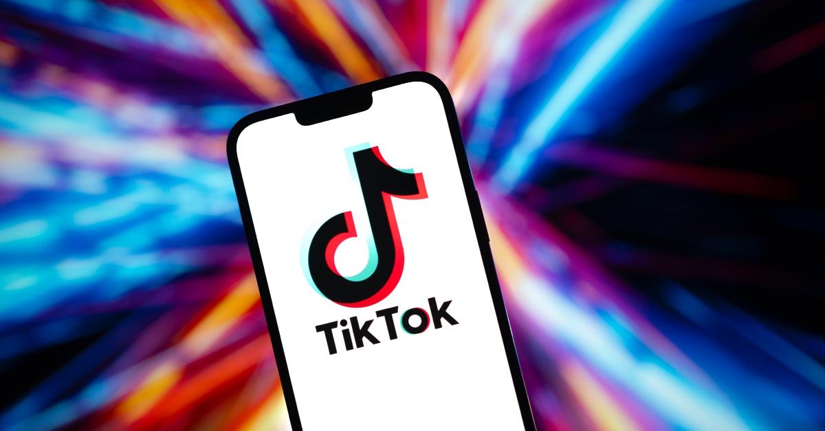 TikTok app on phone with colorful background.