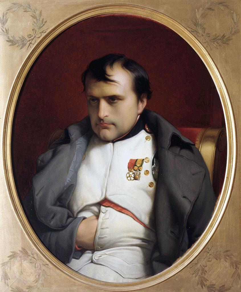 A round, framed portrait of Napoleon Bonaparte hiding his hand