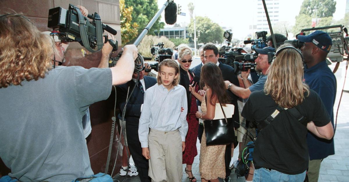 Model Anna Nicole Smith (center, in sunglasses) with her son Daniel and her attorney Philip Boesch walk through the crowd outside the Los Angeles courthouse July 25, 2000 in Los Angeles, Ca. 