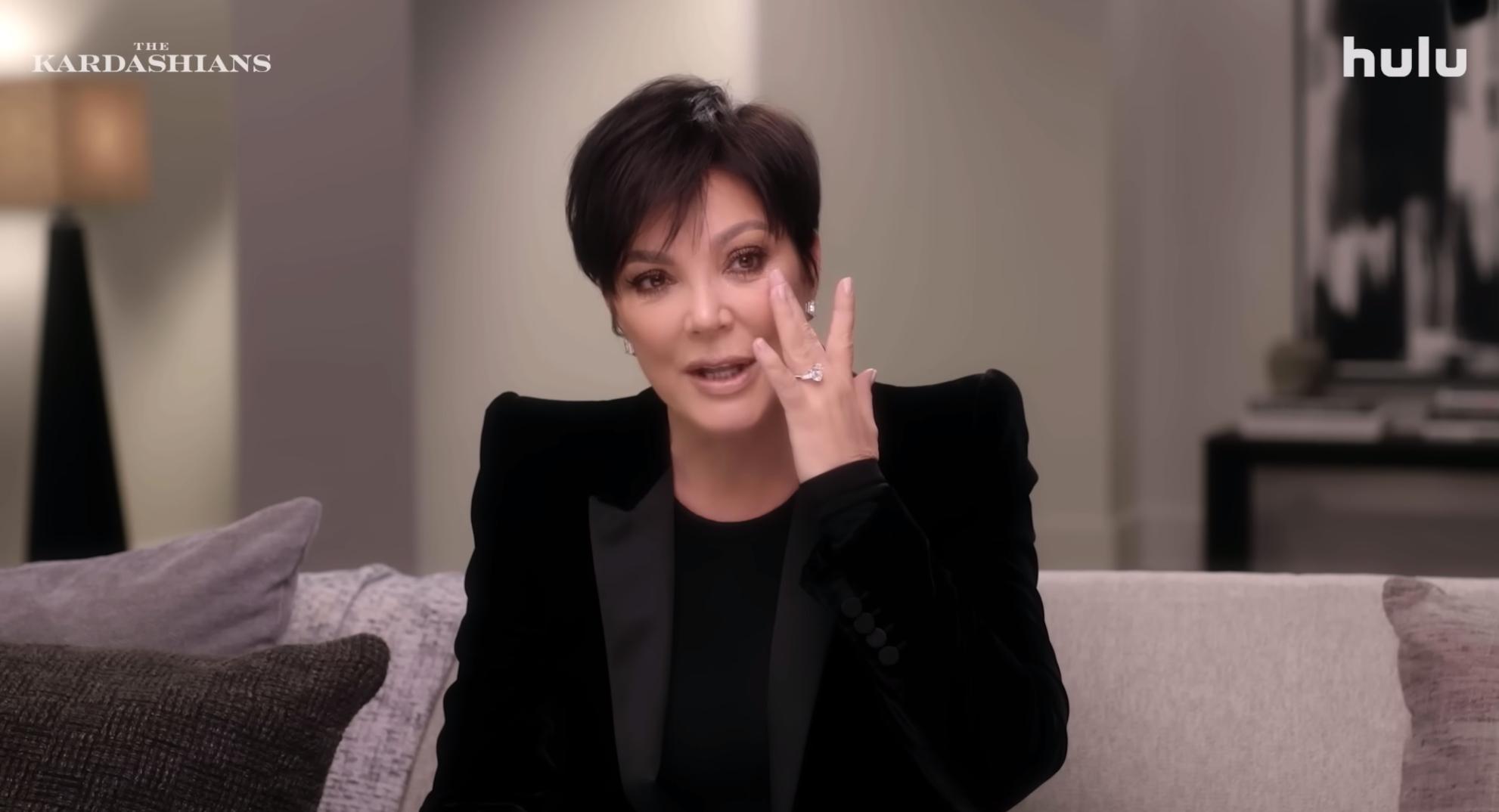 Kris Jenner wipes tears