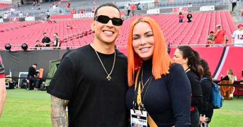 Daddy Yankee and his wife, Mireddys González, attend a football game.