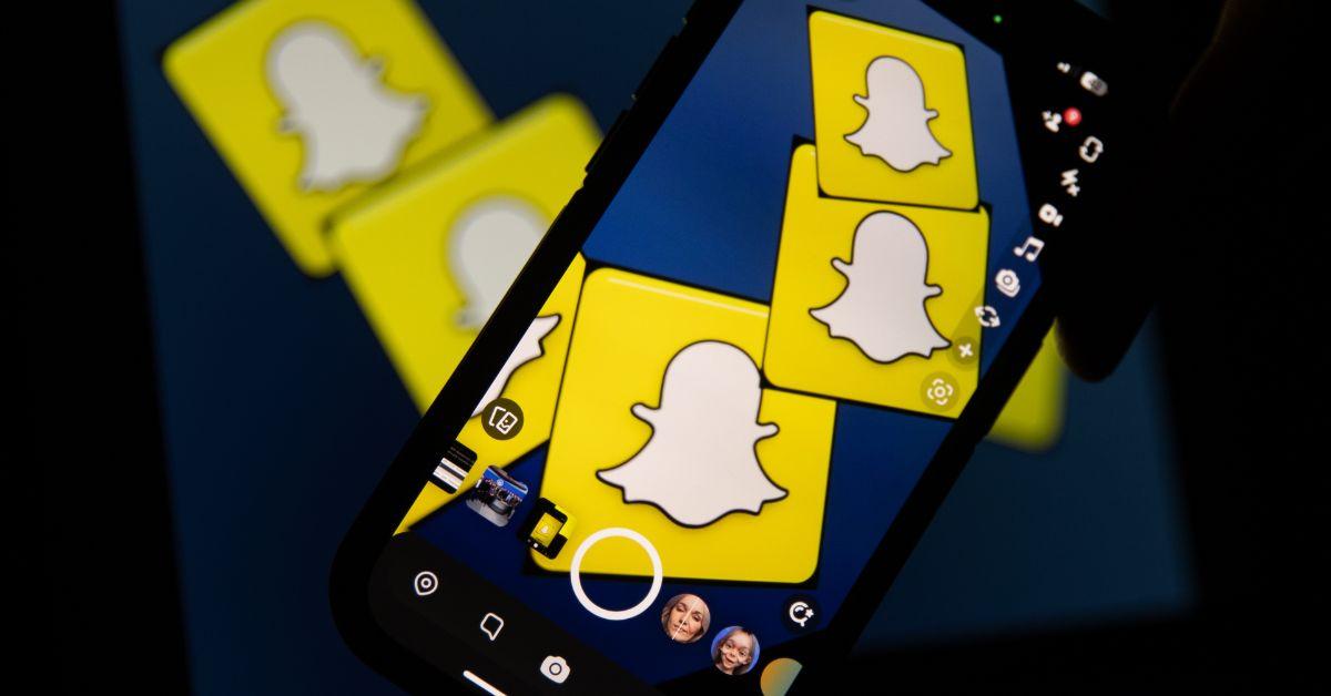 Snapchat logos on a smartphone and computer screen