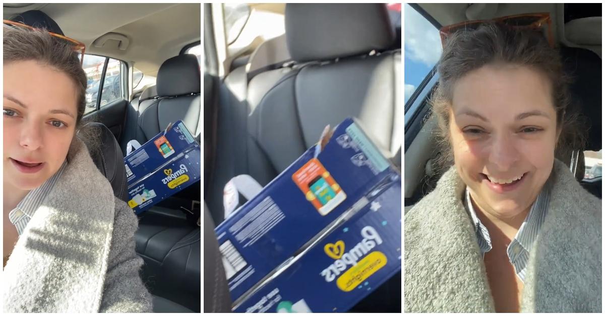 A woman in her car with a damaged diaper box from Target