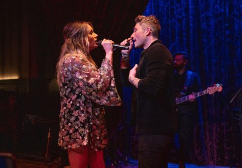 Carly Pearce and Michael Ray doing a duet together.