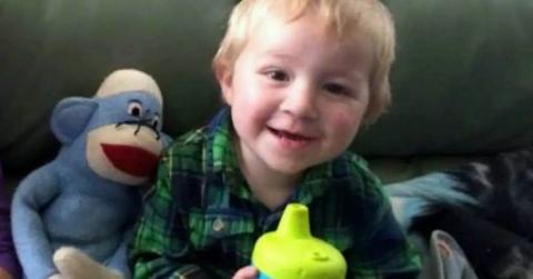 DeOrr Kunz Jr. holding a sippy cup.