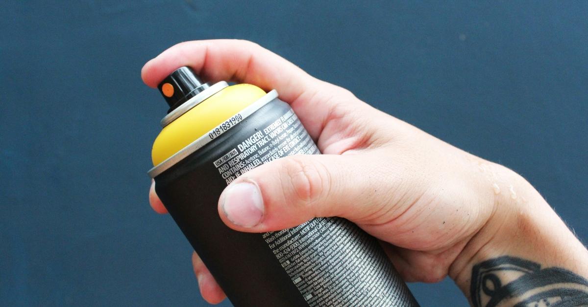 Hand holding a spray can