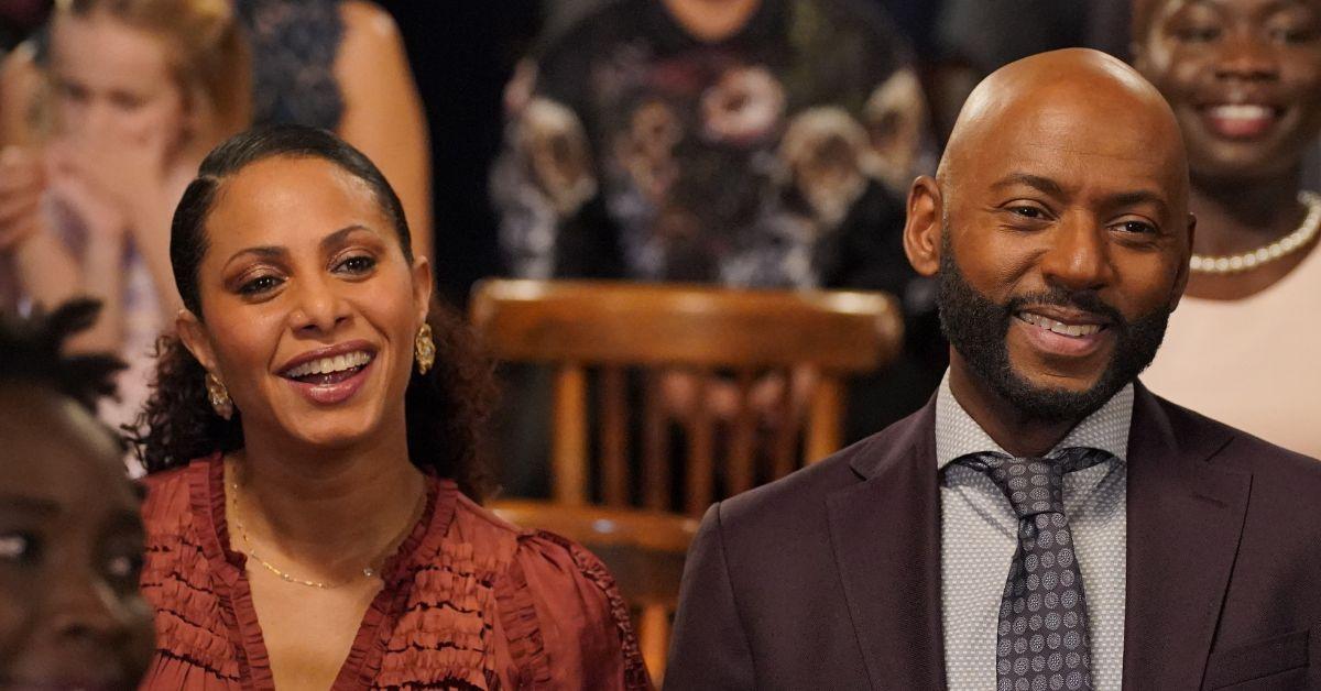 (l-r): Christina Moses as Regina and Romany Malco as Rome smiling at Katherine's wedding in 'AMLT'