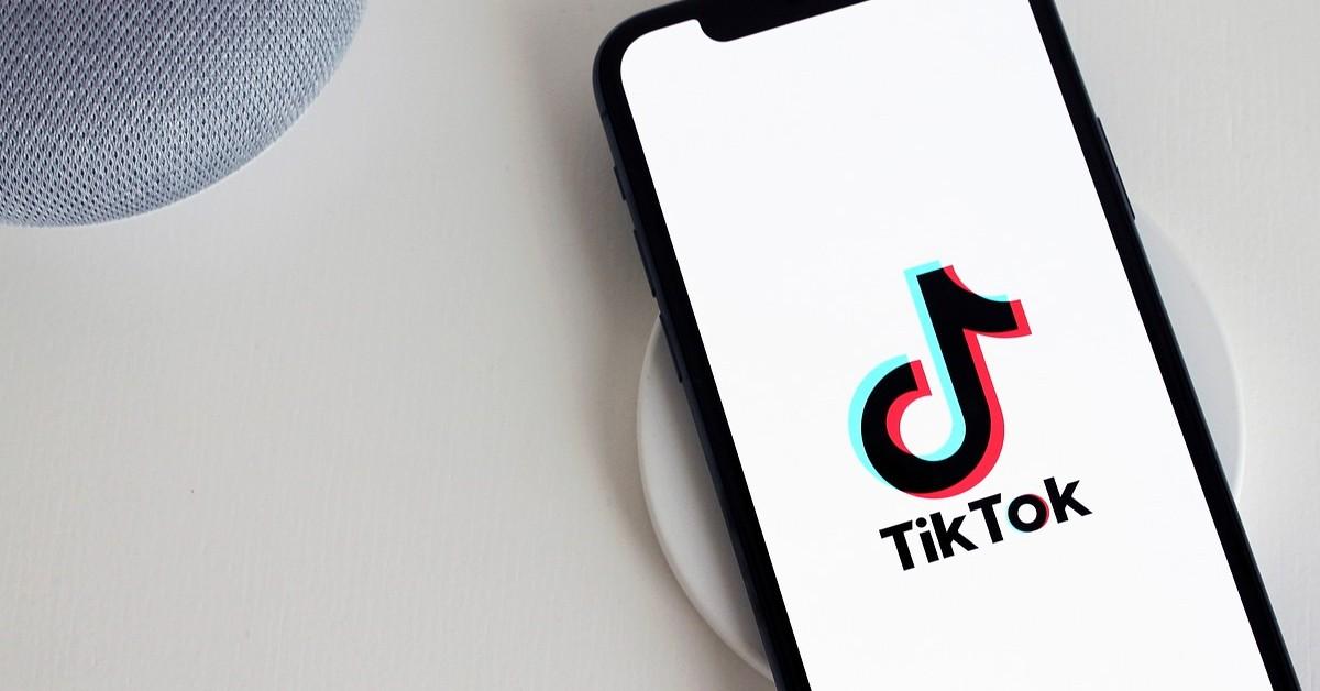 TikTok logo on a phone on a purple background