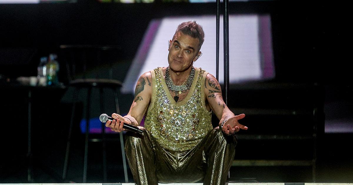 Robbie Williams performing on stage in 2023. 