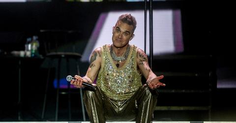 Robbie Williams performing on stage in 2023.