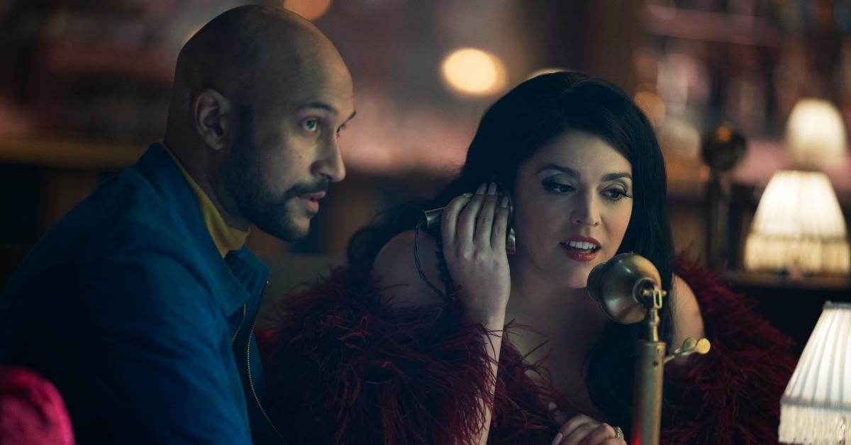 Keegan Michael-Key and Cecily Strong talking on a rotary phone in Season 2 of 'Schmigadoon!'. 