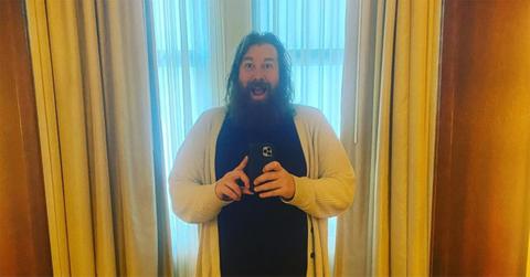 Ben Kissel holding a phone in front of a window