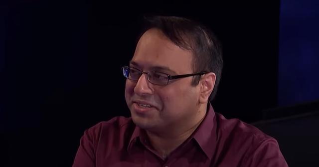 Yogesh Raut wears glasses and a red collared shirt