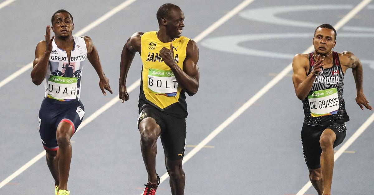 RIO DE JANERIO, BRAZIL - AUGUST 14: Usain Bolt of Jamaica (C) smiles as he looks at Canada's Andre De Grasse (R) in the Men's 100 meter semifinal of the Rio 2016 Olympic Games in Rio de Janeiro, Brazil on on August 14, 2016. (Photo by Salih Zeki Fazlolu/Anadolu Agency/Getty Images)