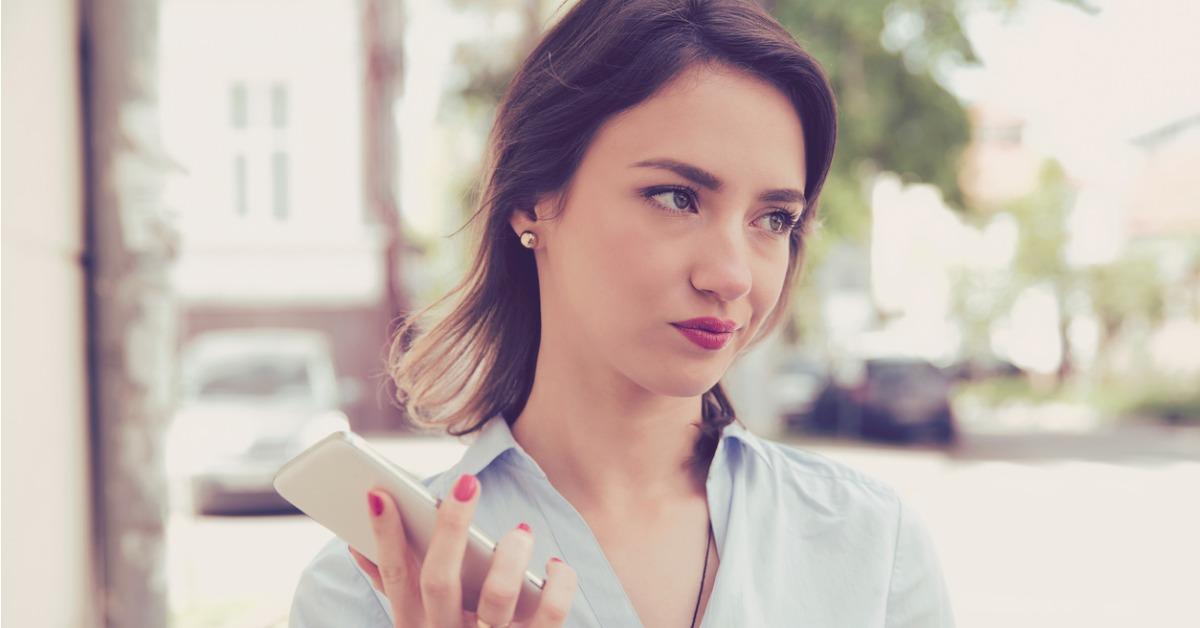 frustrated annoyed sad woman with mobile phone standing outside in picture id