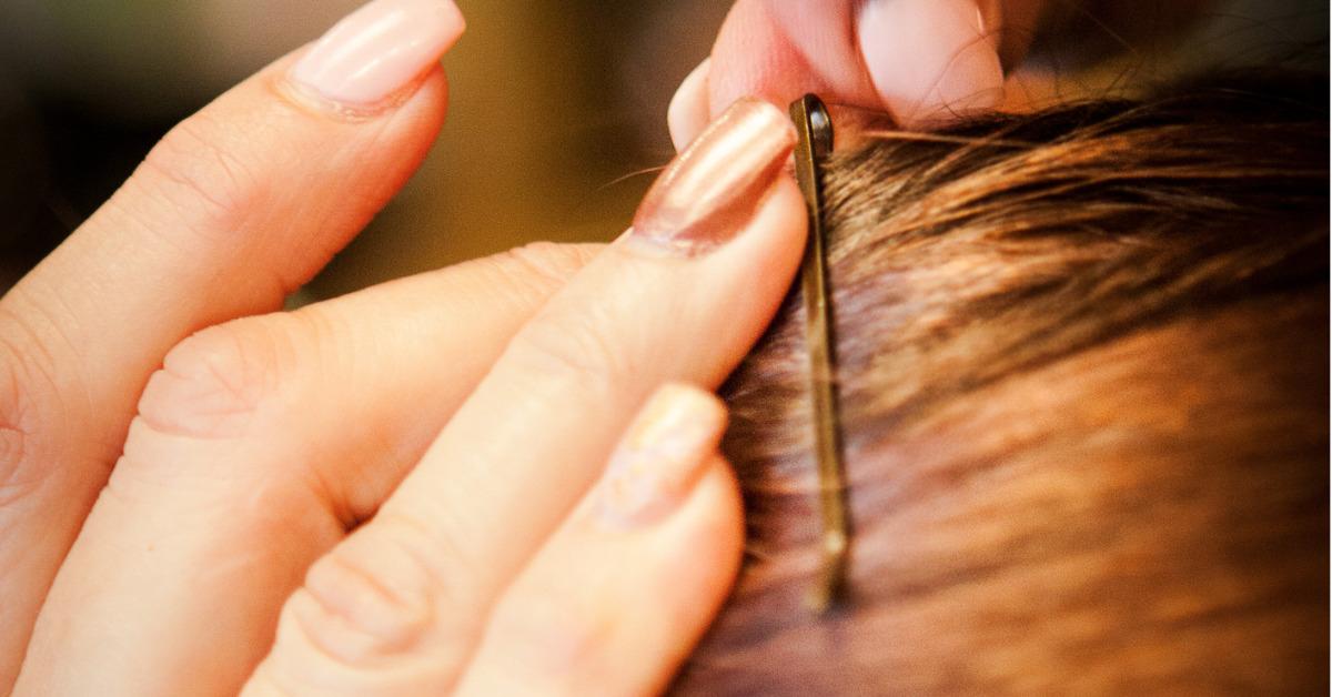 hairdresser stylist adds bobby pin to hair wrap picture id