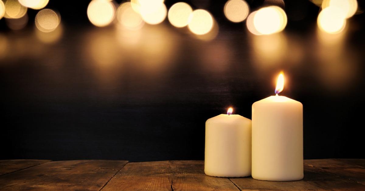 burning candles over old wooden table with bokeh lights picture id