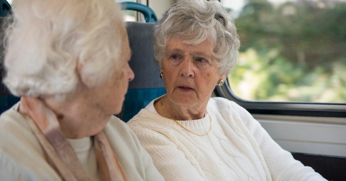 two senior women talking on a train picture id()