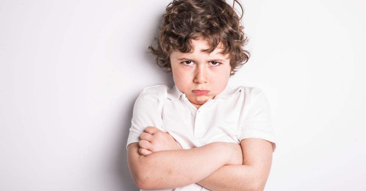 head and shoulders close up portrait of young boy with sulk attitude picture id