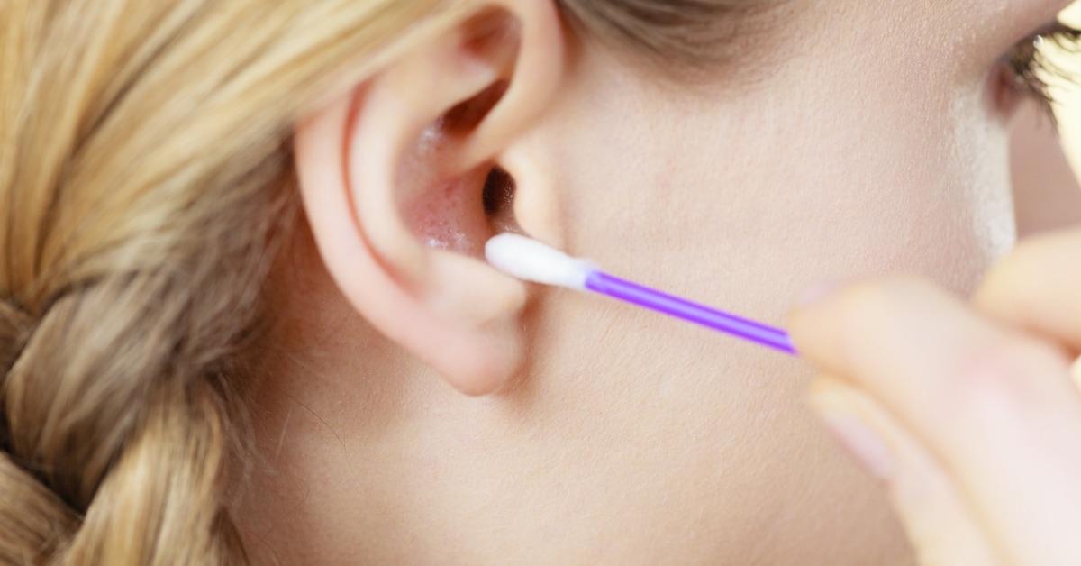 woman cleaning ear with cotton swabs closeup picture id