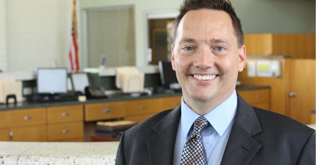 businessman standing in office and smiling picture id