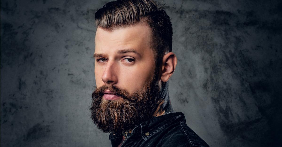 bearded male in black shirt with tattoo on his neck picture id