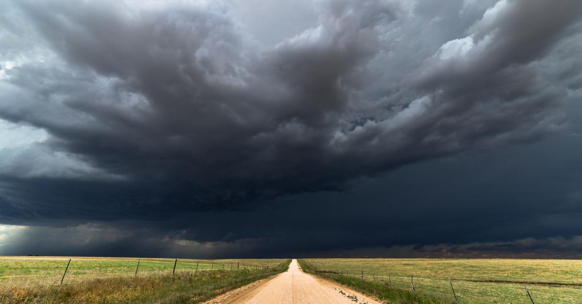 dark storm clouds over a dirt road picture id