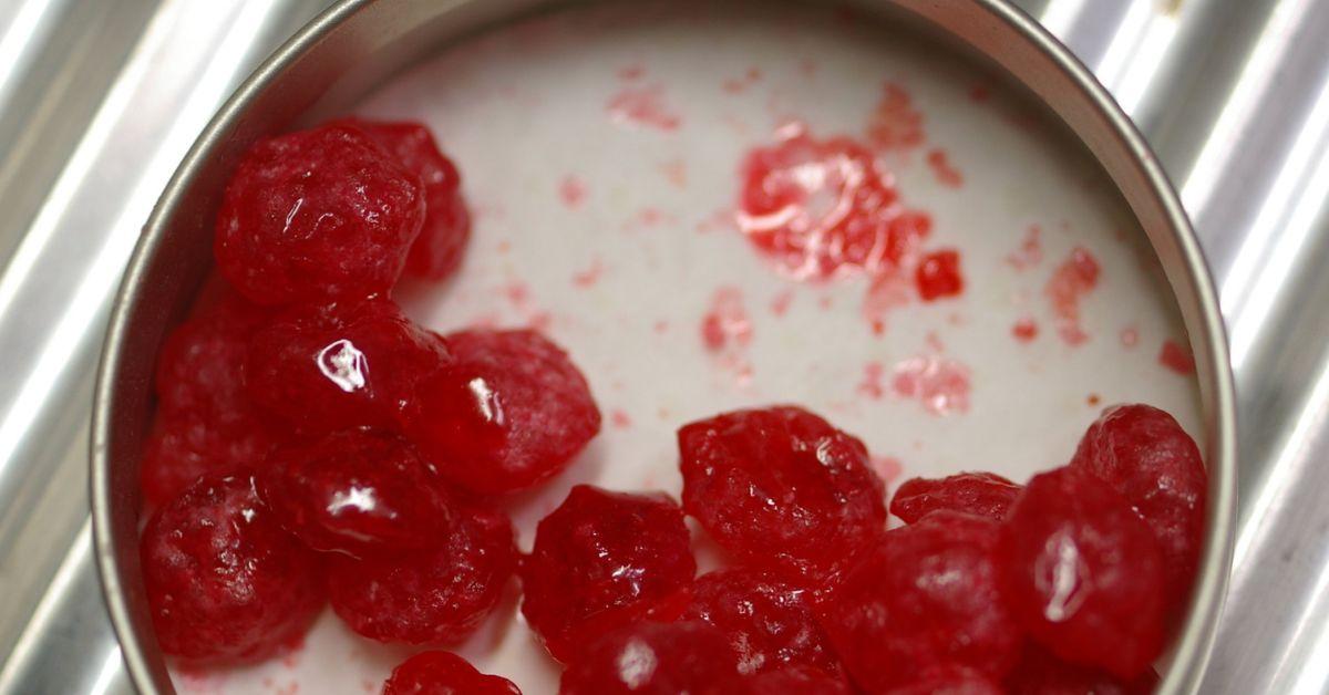 Shriveled red fruit in a dish. 