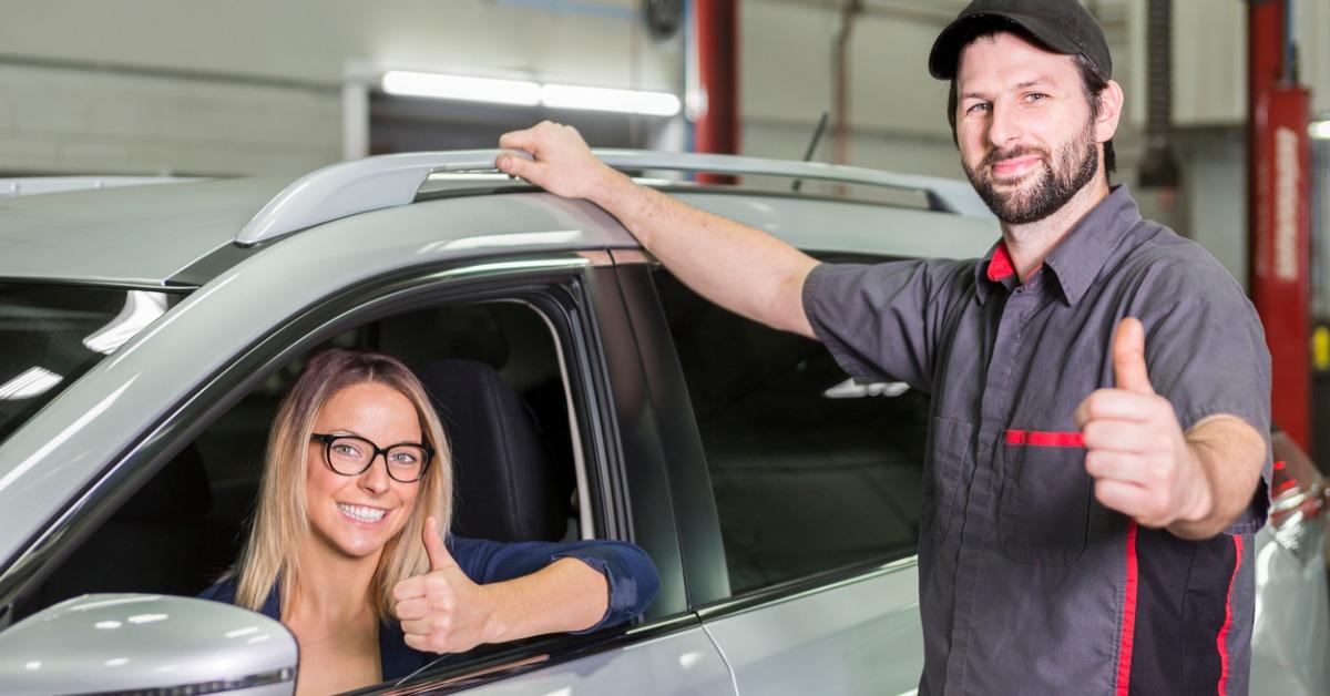 auto mechanic and female customer in garage picture id