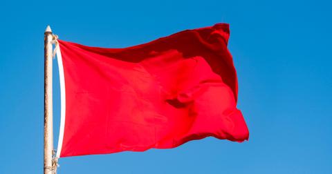 old red flag and blue sky red banner waving against blue sky picture id