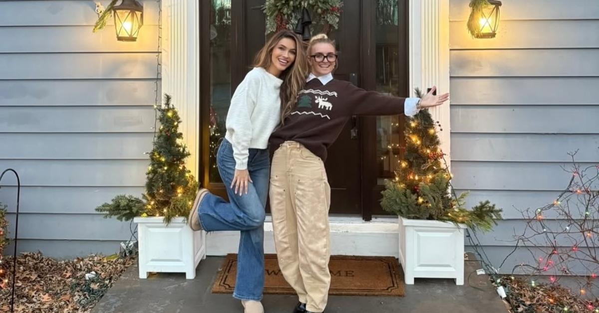 Chrishell and G Flip stand in front of their door for the holidays.