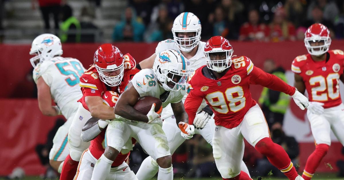 Salvon Ahmed of Miami Dolphins (C) and George Karlaftis of Kansas City Chiefs and Tershawn Wharton of Kansas City chiefs (R) compete for the ball during NFL match between Miami Dolphins and Kansas City Chiefs at Deutsche Bank Park on November 5, 2023 in Frankfurt am Main, Germany. 
