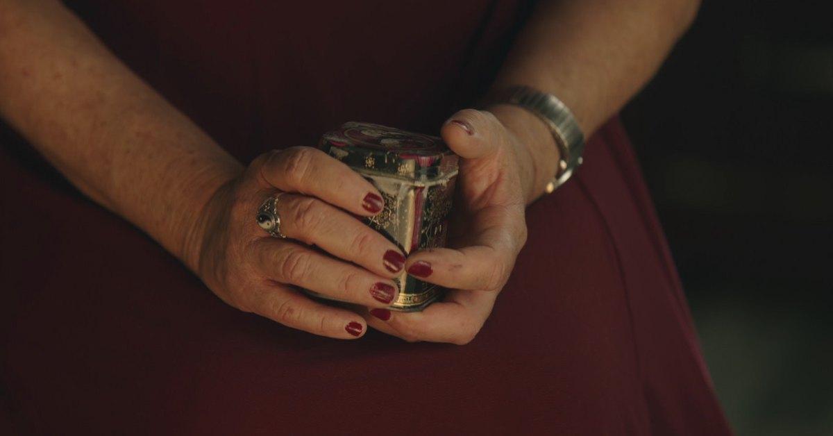 Woman holds ashes of her family member who was created by Lamb Funeral Home.