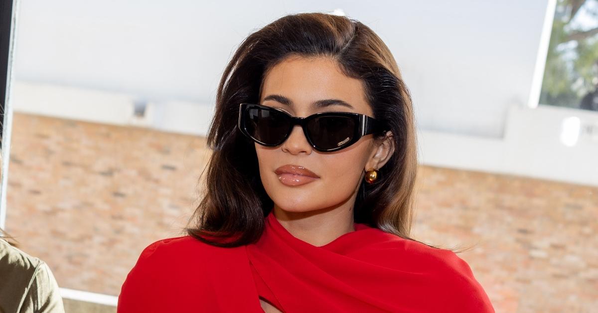 Kylie Jenner in red dress and sunglasses at "Les Sculptures" Jacquemus' Fashion Show in France in January 2024