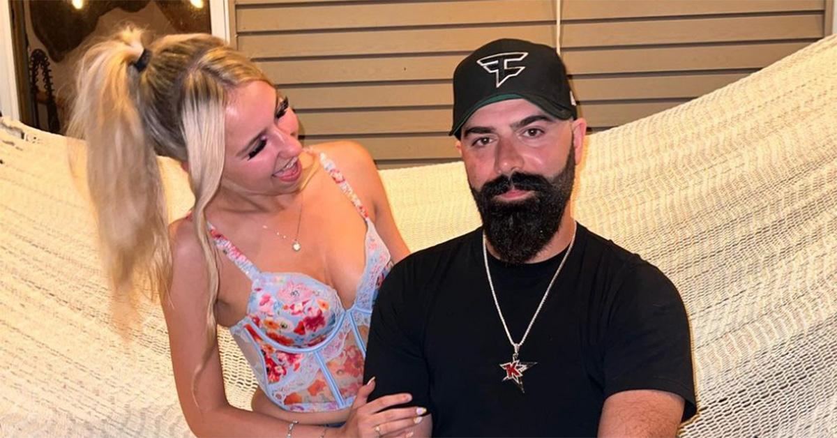 Keemstar with his girlfriend sitting on a hammock. 