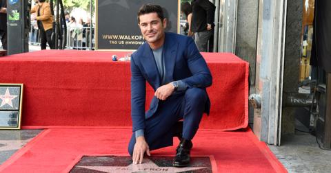 Zac Efron poses with his star on the Hollywood Walk of Fame on Dec. 11, 2023 in Los Angeles.