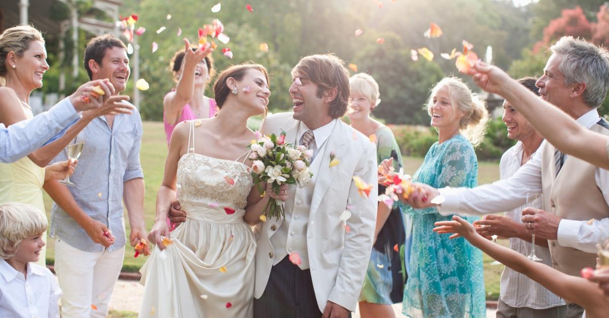 flower petals being tossed at the bride and groom