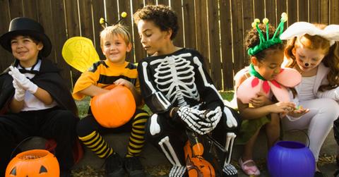 children celebrating halloween in costumes