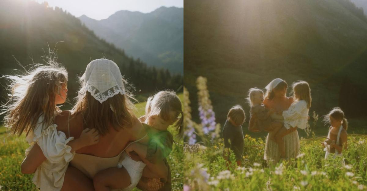 Amber holds children in a field while wearing a white lace bandana.