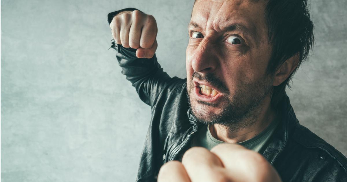 aggressive man punching with fist picture id