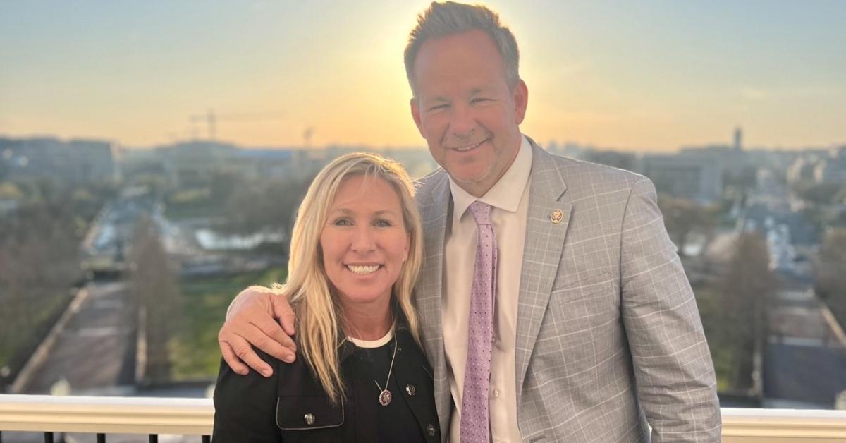 Marjorie Taylor Greene and Brian Glenn on a rooftop patio.
