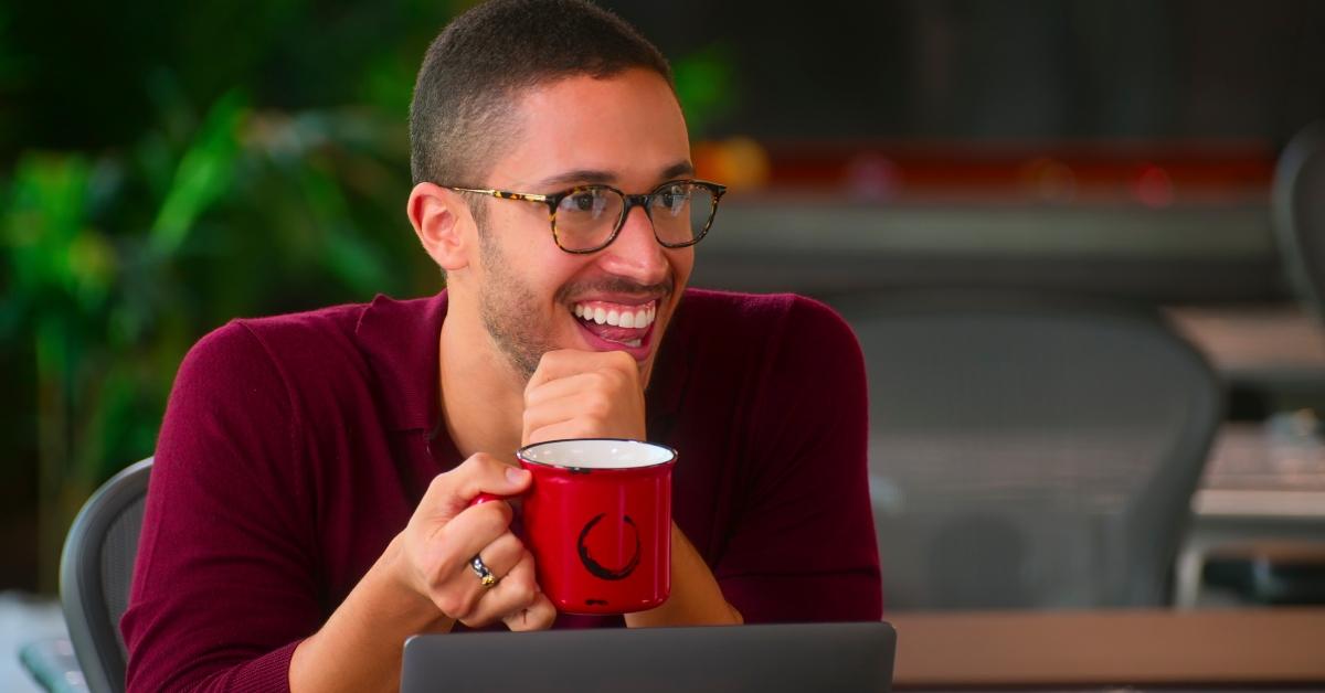 sean Palmieri sitting at a desk in the oppenheim group office