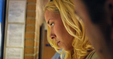 Kim Mathers fills out paperwork at the cashier's window of St. Clair Shores District Court