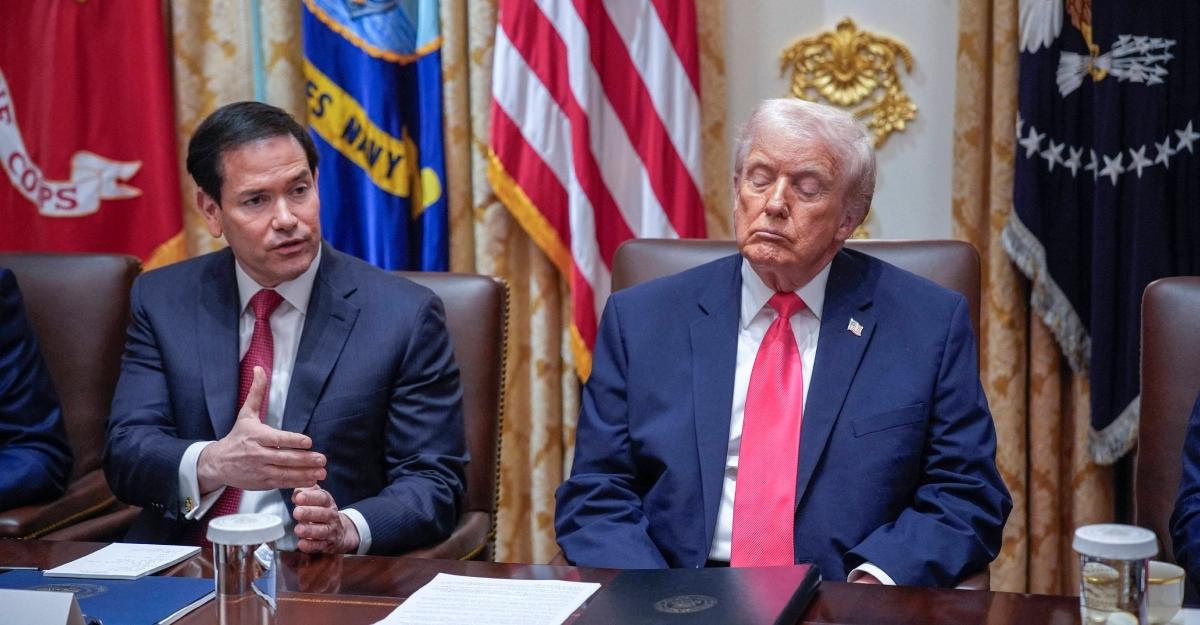 Trump looks down at the desk, appearing to close his eyes in a cabinet meeting.