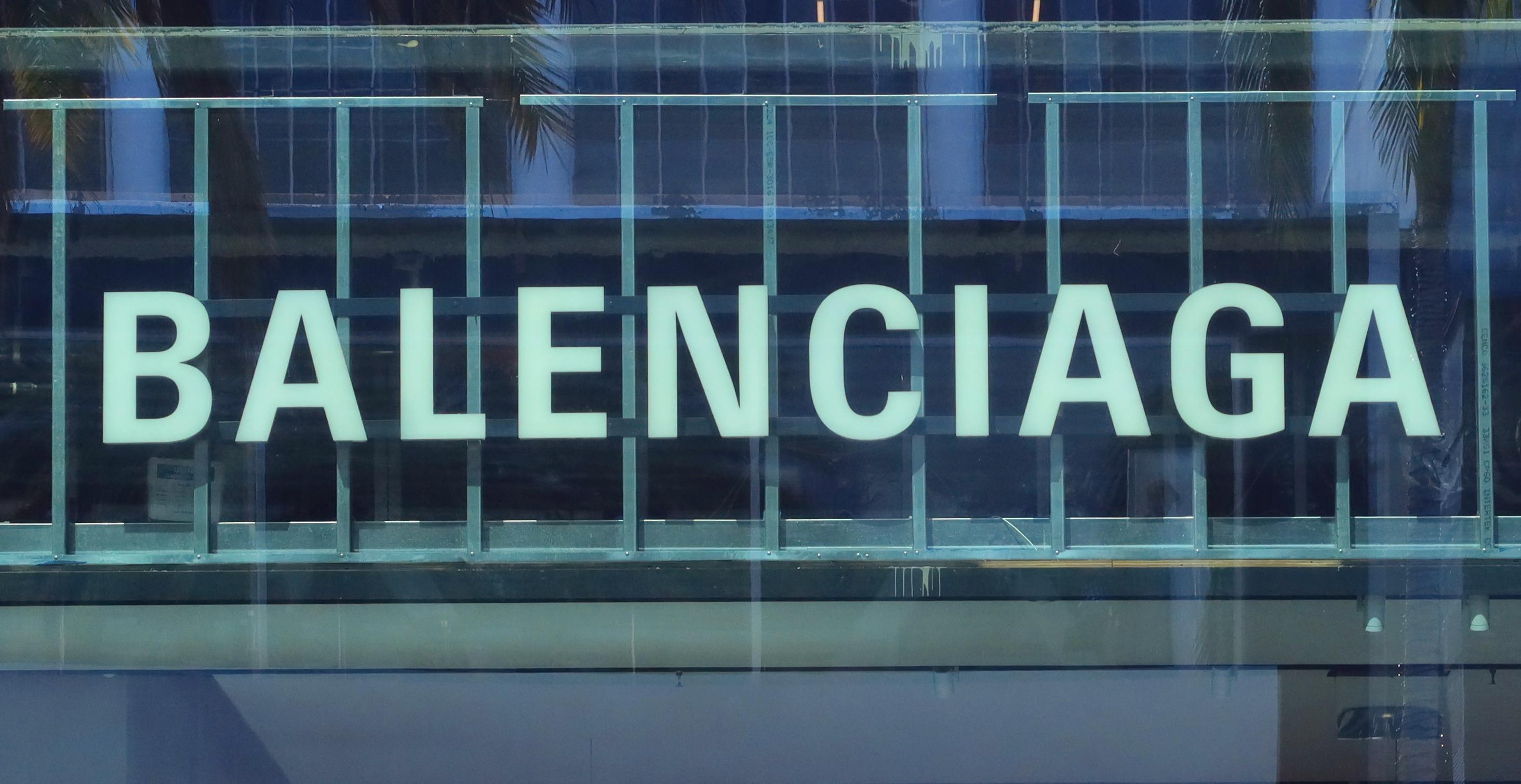 Balenciaga corporate logo hangs in the front window of their store on Rodeo Drive.