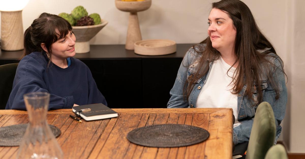 Gracie Lou and Naomi sit at a table together on Claim to Fame